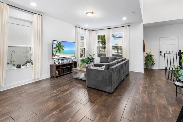 living room with recessed lighting, baseboards, and dark wood finished floors