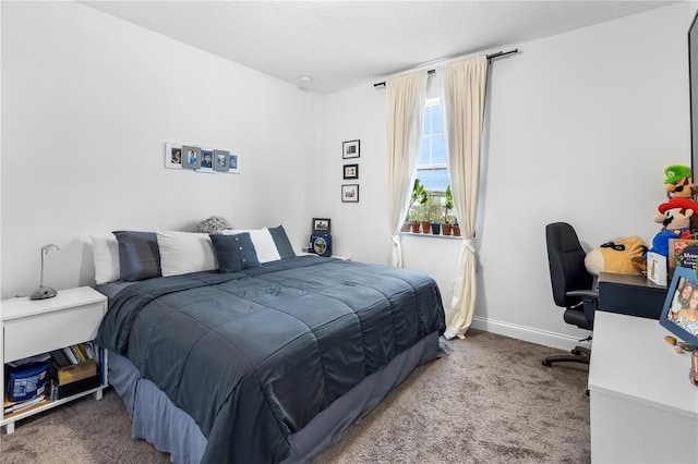 bedroom featuring baseboards and carpet