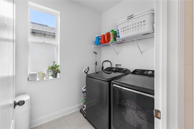 laundry area with washer and dryer, laundry area, light tile patterned floors, and baseboards