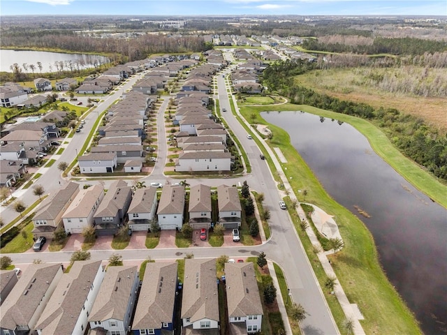 birds eye view of property featuring a water view and a residential view