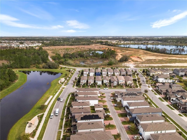 drone / aerial view featuring a residential view and a water view