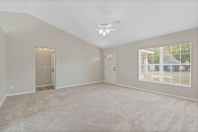 unfurnished room with light carpet, baseboards, lofted ceiling, and ceiling fan