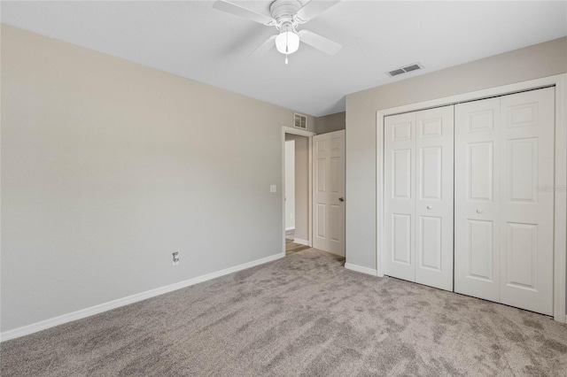 unfurnished bedroom featuring visible vents, baseboards, carpet, and a closet