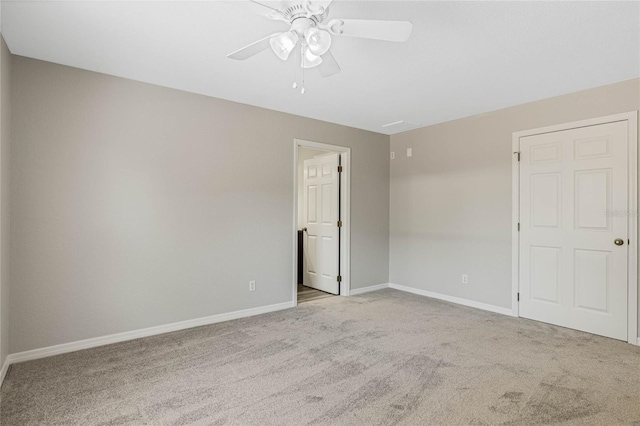 empty room featuring carpet flooring, baseboards, and ceiling fan