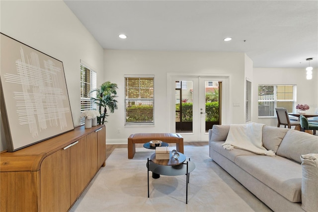 living area with plenty of natural light, french doors, recessed lighting, and baseboards