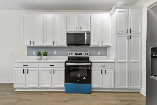 kitchen featuring light countertops, white cabinets, light wood-type flooring, and appliances with stainless steel finishes