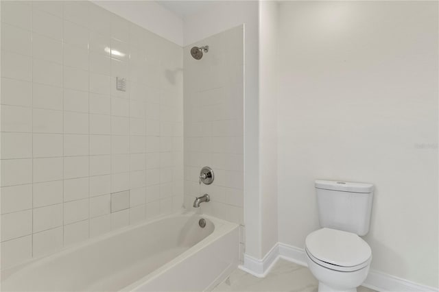 bathroom with toilet, shower / bathing tub combination, and baseboards