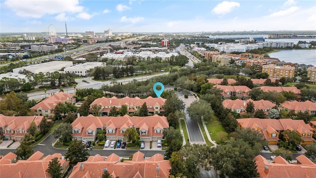 drone / aerial view featuring a residential view and a water view