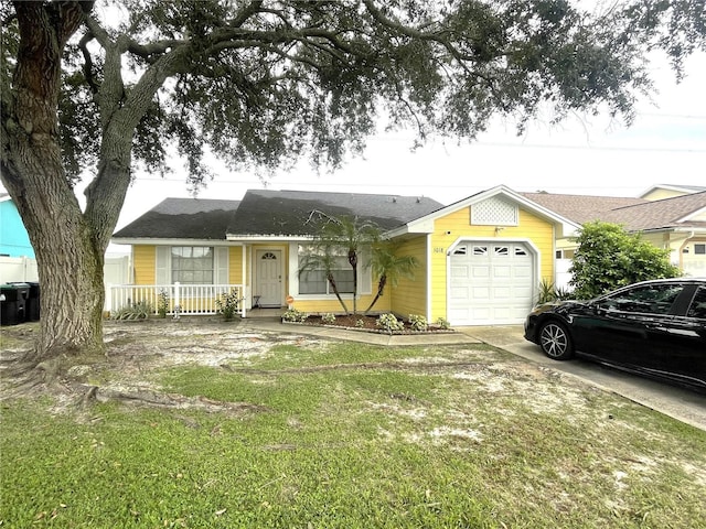 ranch-style house with a garage, driveway, covered porch, and a front lawn