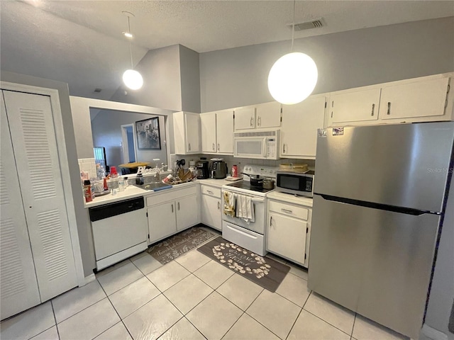 kitchen featuring visible vents, decorative light fixtures, light countertops, light tile patterned floors, and stainless steel appliances