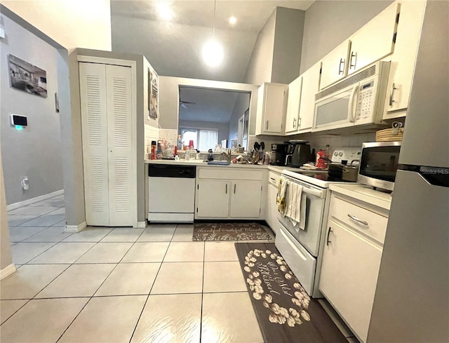 kitchen featuring white cabinetry, white appliances, light tile patterned flooring, light countertops, and baseboards