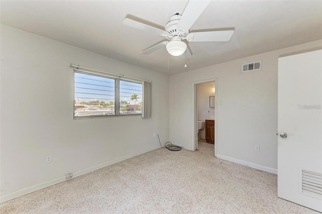 unfurnished bedroom featuring visible vents, a ceiling fan, light speckled floor, connected bathroom, and baseboards