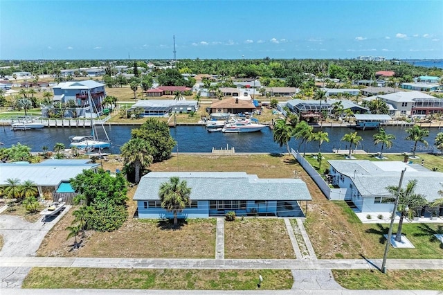 drone / aerial view featuring a residential view and a water view