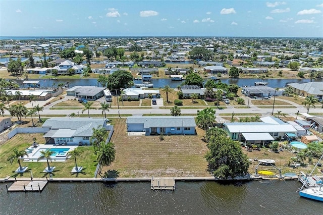 birds eye view of property with a residential view and a water view