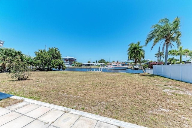 view of yard featuring fence and a water view