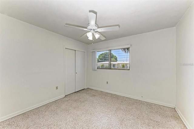 spare room with ceiling fan, speckled floor, and baseboards