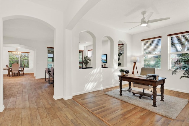 office with a wealth of natural light, light wood-style flooring, a ceiling fan, and baseboards