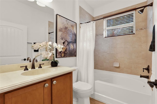 bathroom with vanity, shower / tub combo, and toilet