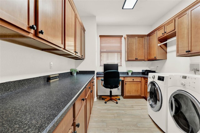 laundry area with washing machine and dryer, cabinet space, and light wood finished floors