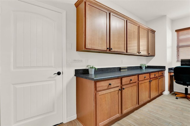 interior space with baseboards and light wood-style floors