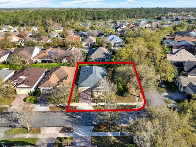 bird's eye view featuring a forest view and a residential view