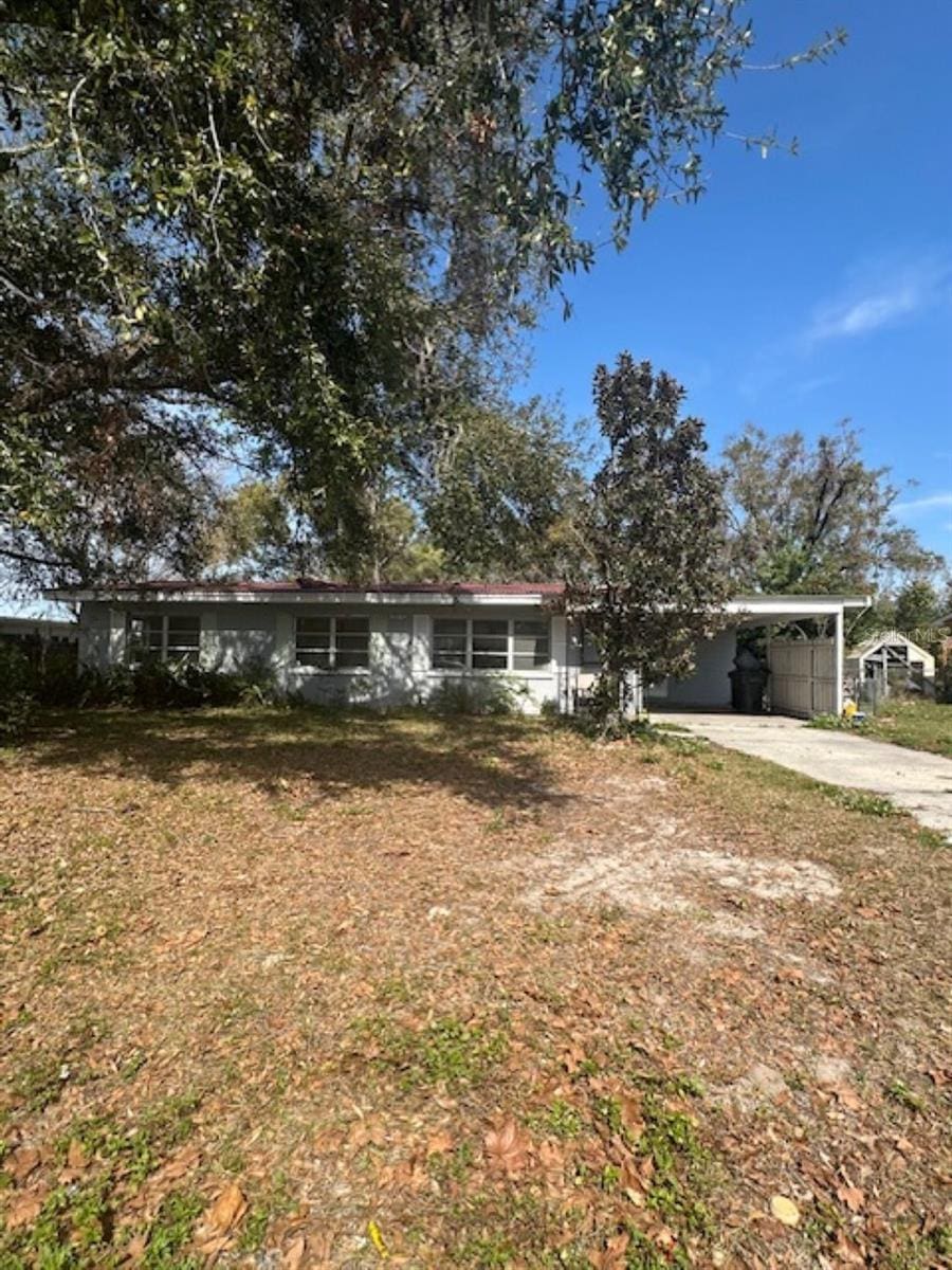 single story home with a carport and driveway