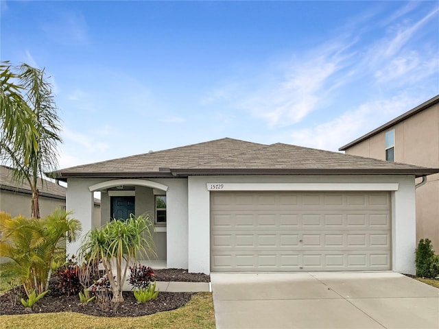 single story home with stucco siding, concrete driveway, and a garage