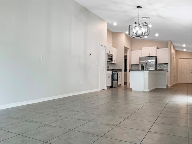 kitchen featuring stainless steel appliances, vaulted ceiling, white cabinets, dark countertops, and open floor plan