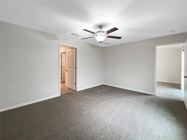 unfurnished room with visible vents, baseboards, ceiling fan, and carpet flooring