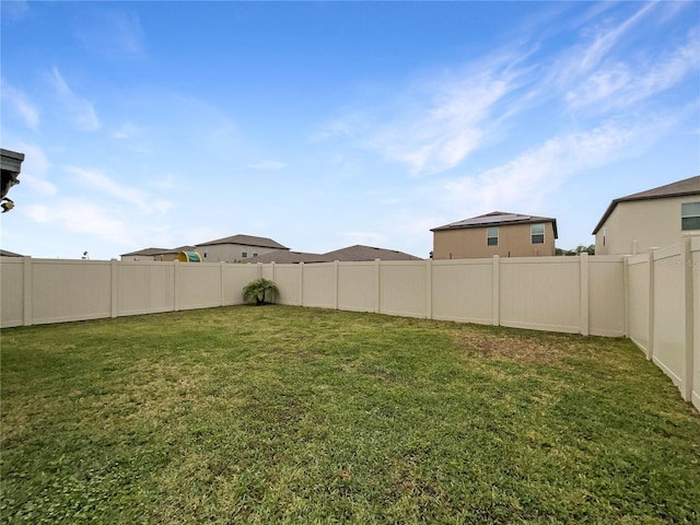 view of yard with a fenced backyard