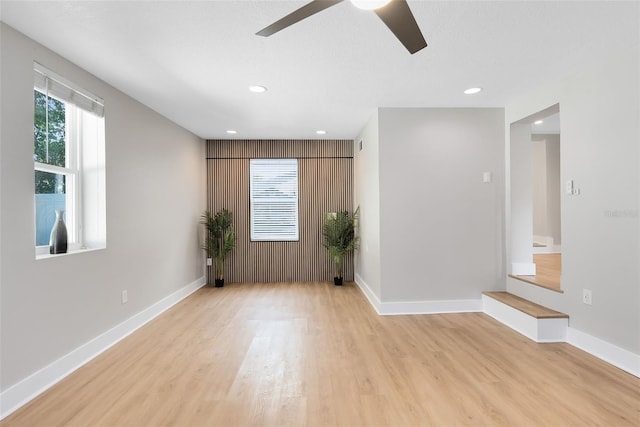 empty room featuring recessed lighting, light wood-style flooring, baseboards, and ceiling fan