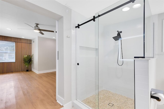 full bathroom with a ceiling fan, wood finished floors, recessed lighting, a shower stall, and baseboards