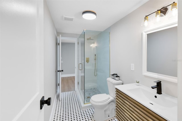 bathroom with visible vents, a stall shower, toilet, and vanity