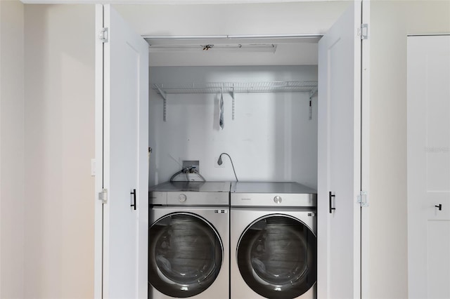 washroom featuring laundry area and separate washer and dryer