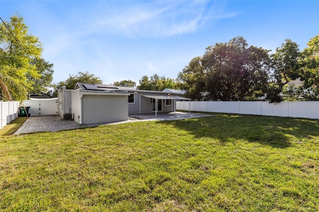 view of yard with a patio area, a fenced backyard, and a gate