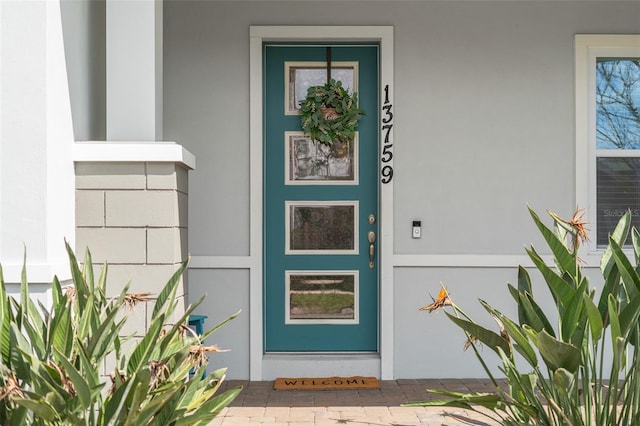 view of exterior entry with stucco siding