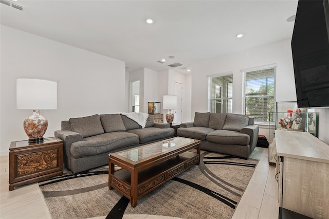 living area with visible vents, recessed lighting, and light wood-type flooring