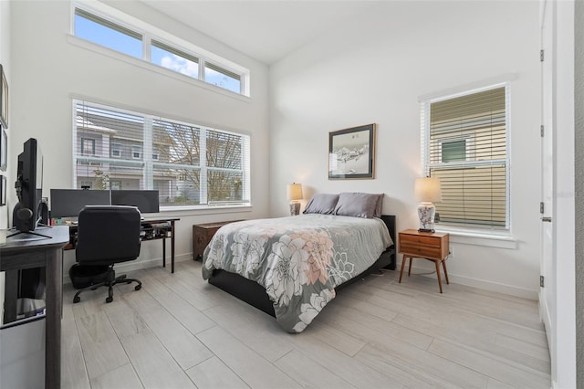 bedroom with baseboards and light wood-style floors