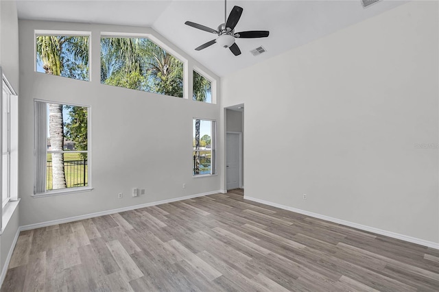 unfurnished room with visible vents, a ceiling fan, baseboards, and wood finished floors