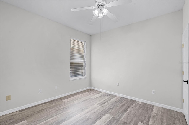 unfurnished room featuring baseboards, light wood-style floors, and a ceiling fan