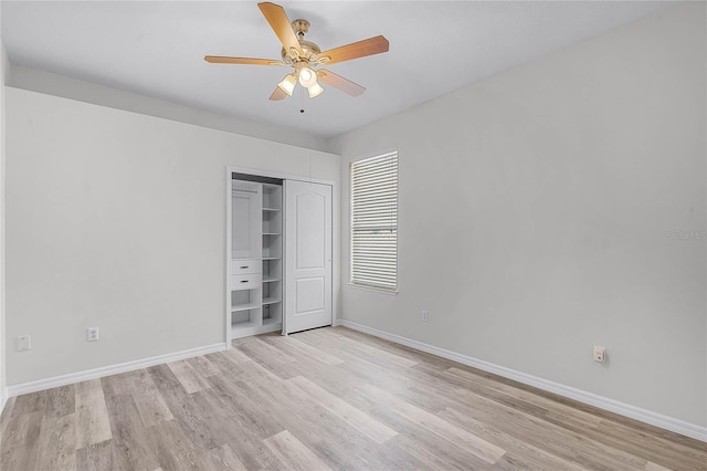 unfurnished bedroom with ceiling fan, a closet, baseboards, and light wood-style flooring