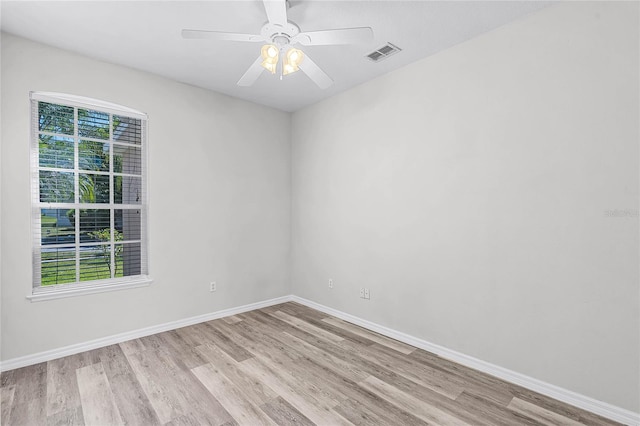 unfurnished room with light wood-type flooring, visible vents, baseboards, and a ceiling fan