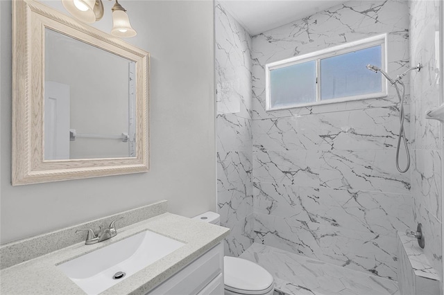 full bath featuring a marble finish shower, toilet, and vanity