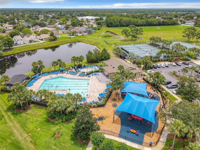 drone / aerial view with a water view and view of golf course