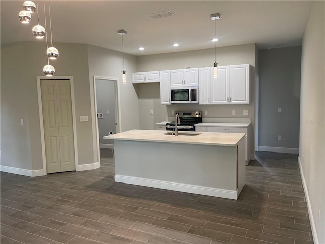 kitchen with visible vents, white cabinetry, stainless steel appliances, light countertops, and wood tiled floor