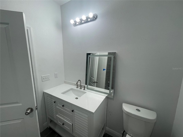 bathroom featuring toilet and vanity