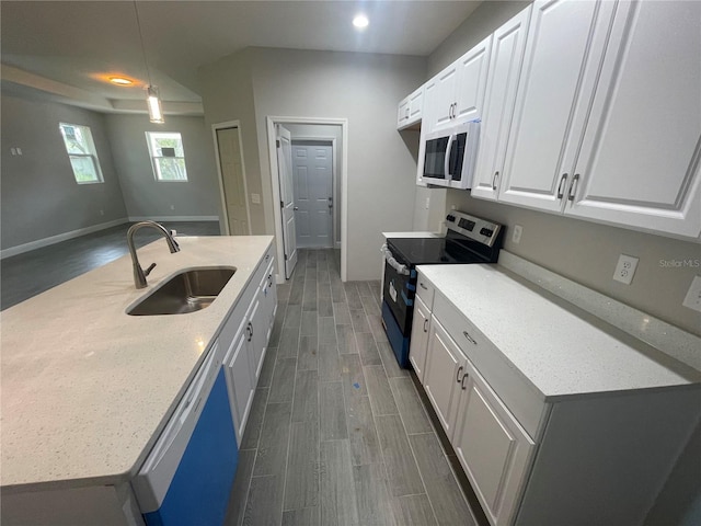 kitchen with baseboards, wood tiled floor, stainless steel range with electric stovetop, white cabinetry, and a sink