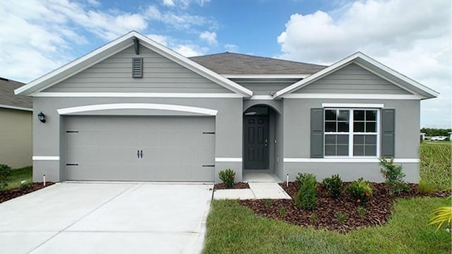 single story home featuring stucco siding, concrete driveway, and an attached garage