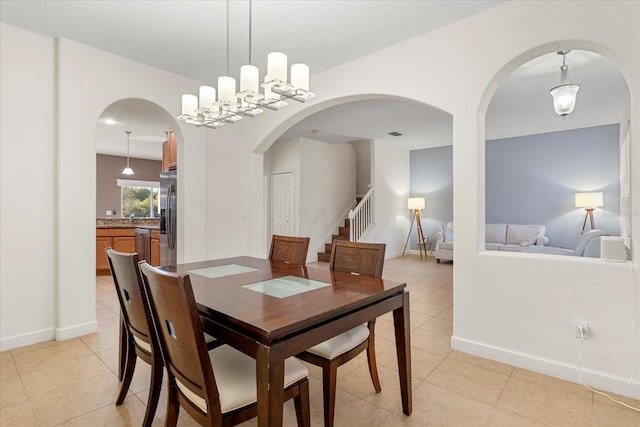 dining space with stairway, light tile patterned flooring, and baseboards