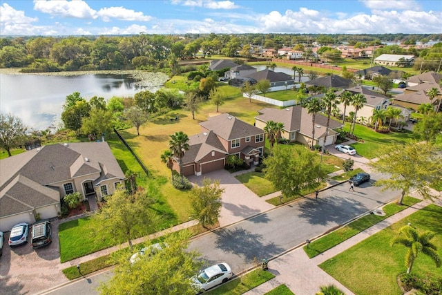 drone / aerial view with a residential view and a water view